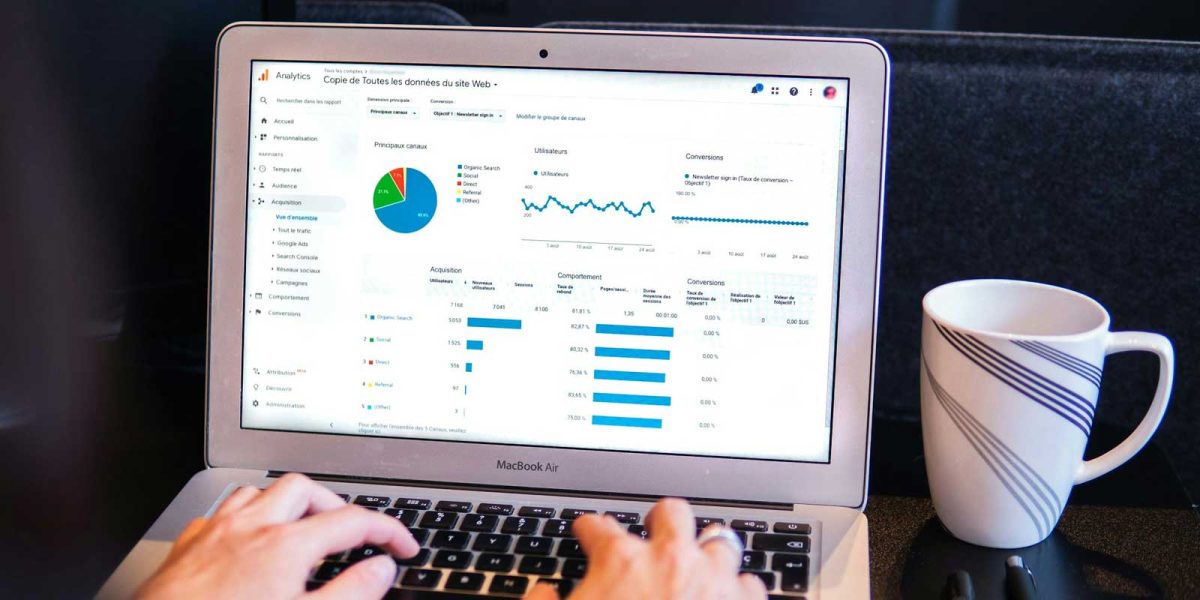Person analyzing e-commerce website analytics on a laptop to improve product page performance and customer trust.