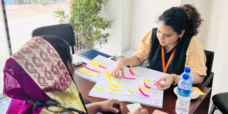 Human-centered qualitative field research session with participants using paper-based mapping materials.